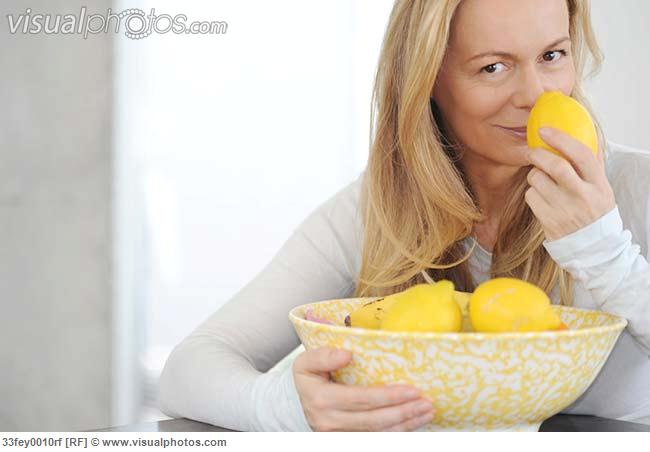 Woman smelling lemons